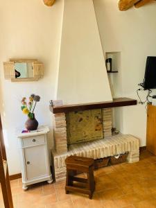 a living room with a brick fireplace with a table at CIRIBACCO ROOMS in Macerata
