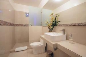 a white bathroom with a sink and a toilet at Hotel del Angel in Guadalajara