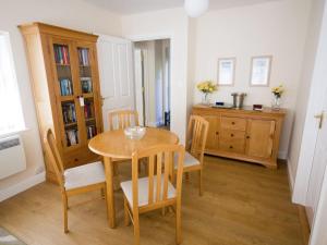 a dining room with a wooden table and chairs at The Lodge at Orchard House in Norwich +14 photos