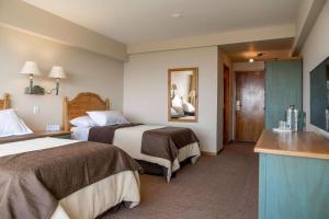 Cama ou camas em um quarto em Wyndham Garden Ushuaia Hotel del Glaciar