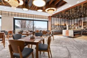 a restaurant with tables and chairs and a kitchen at Tryp by Wyndham Istanbul Topkapi in Istanbul