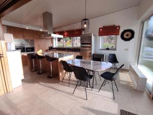 eine Küche mit einem Tisch und Stühlen in der Unterkunft Luxurious Villa in Stavelot with Sauna and Pool in Stavelot