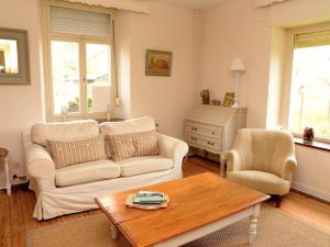 a living room with a couch and a table at AFamily HomeDating Backto the endof the19thCentury in Les Bulles