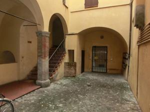 an empty alley with a staircase in a building at Love and More House in Imola