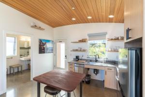 a kitchen with a table and a refrigerator at Anchor Inn Pacifica in Pacifica