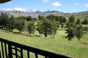 a view of the mountains from the balcony of a house at Fairways Holiday Accommodation in Drakensberg Garden