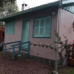 una casa con una porta blu e una panchina all'esterno di Haus Berg a São Francisco de Paula