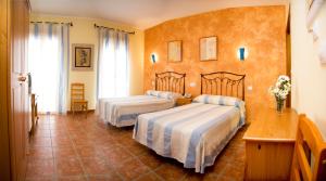 Posteľ alebo postele v izbe v ubytovaní Hotel Rural El Arriero