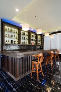 a bar in a restaurant with wooden stools at Northpointe Residences in Manila