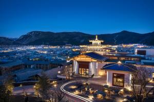 a view of a city at night with a building at Hotel Indigo Diqing Moonlight City, an IHG Hotel in Shangri-La