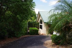 a small white house with a green roof at Limpinwood Lodge in Limpinwood