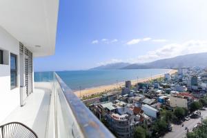 a balcony with a view of the beach and buildings at TMS-PULLMAN MINH MINH Apartment in Quy Nhon