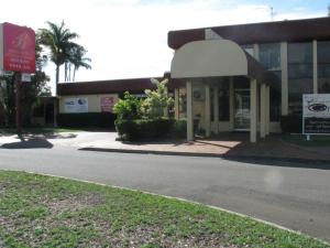 a large building with a sign on the side of it at Bundaberg International Motor Inn in Bundaberg