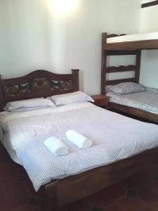 a bed with two white towels on top of it at Hostal Rana in Villa de Leyva +29 photos
