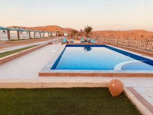 a swimming pool in the middle of the desert at Bedouin Oasis Desert Camp- Ras Al Khaimah in Ras al Khaimah