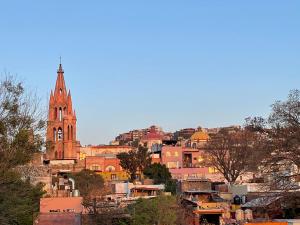 
a clock tower in the middle of a city at Hotel Casa San Miguel in San Miguel de Allende
