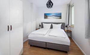 Säng eller sängar i ett rum på Strandloft Drei Norderney