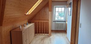 a attic room with a staircase with a window at Ferienwohnung Stadtvilla in Magdeburg