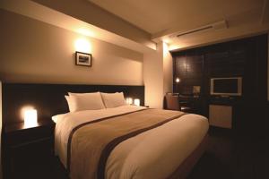 a bedroom with a large bed with lights on it at Sutton Place Hotel Ueno in Tokyo