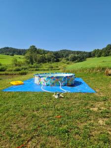 a water park on a field with a blue tarp at Pod Nartami in Hoczew
