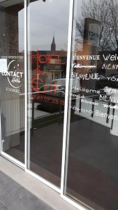 a window of a store with signs on it at Contact Hôtel du Cerf in Château-Gontier +57 photos