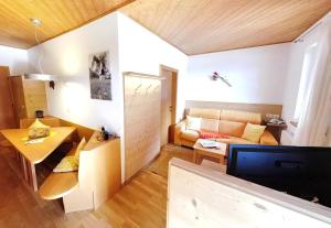 a living room with a couch and a table at Appartements Grumserhof in Merano +27 photos