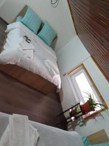 a bedroom with a bed with a mirror and a window at Casa Radu in Tulcea +7 photos