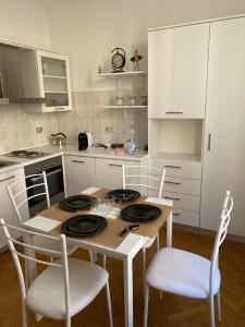 a kitchen with a table and chairs in a kitchen at Corso Italia 4 in Bordighera