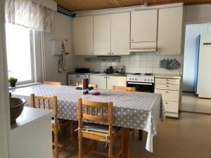 a kitchen with a table with a polka dot table cloth at Wilderness Estate Pukari, Kuusamon Erämajoitus in Kuusamo