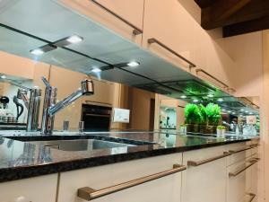 a kitchen with a sink and a large mirror at Breathtaking Waterfall Apartment nr 3 in Lauterbrunnen