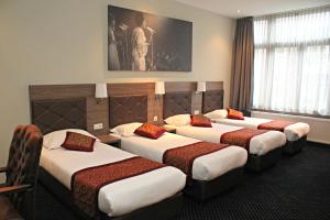 Postel nebo postele na pokoji v ubytování Hotel Washington
