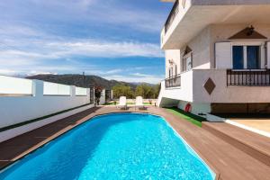 a swimming pool in front of a house at Villa Kounoupas, comfy villa with swimming pool up to 8 guests! in Lamerianá