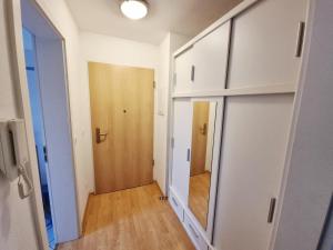 a hallway with a closet and a mirror and a door at Ferienapartment Usedom in Ostseebad Koserow