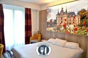 a hotel room with a castle painting on the wall at Kyriad Hotel Tours Centre in Tours +55 photos