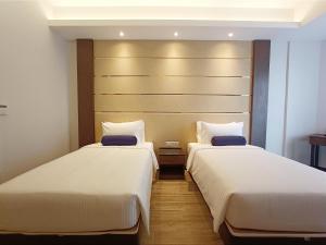 Letto o letti in una camera di Pacific Regency Beach Resort, Port Dickson