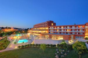 a hotel with a swimming pool and a building at Hotel Albatros Plava Laguna in Poreč