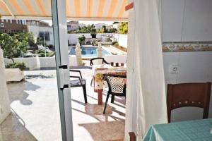 a view of a patio with a table and chairs at PRECIOSA CASA CON PISCINA AL LADO DE LA PLAYA in Miami Platja