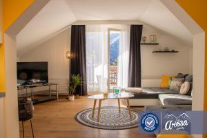 
a living room filled with furniture and a window at Haus Hermann in Arosa
