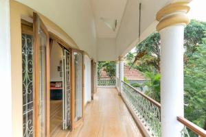 an empty porch of a house with a balcony at Casa Do Amor by VEO - Part of StayVista in Sangolda