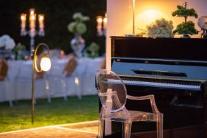 a plastic chair sitting in front of a piano at Villa Hermitage in Vabriga +40 photos