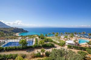 an aerial view of the resort with the ocean in the background at Blue Bay Resort in Capo Vaticano