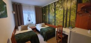 Postel nebo postele na pokoji v ubytování KARCZMA MYŚLIWSKA + 51 fotografií