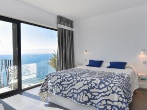a bedroom with a bed and a large window at Sea Heaven 302 by VillaGranCanaria in San Agustin