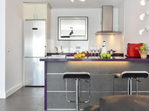 a kitchen with a counter with a sink and a refrigerator at Sea Heaven 302 by VillaGranCanaria in San Agustin