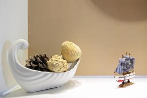 a white cup with ice cream and pine cones on a table at Apartments BrunoR in Dubrovnik