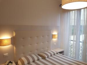 a bedroom with a large bed with a large window at Albergo Degli Amici in Monterosso al Mare