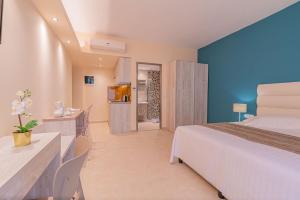 a hotel room with a bed and a television at CHRISTA APARTMENTS in Kos