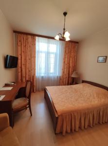 A bed or beds in a room at Derzhavniy Hotel