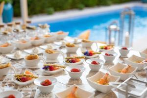 a buffet of food on a table next to a pool at Villa Giulia in Vabriga