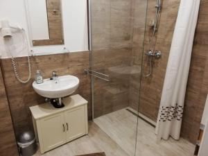 a bathroom with a sink and a shower at Vivi holiday house for 4 people in Nerezine +12 photos